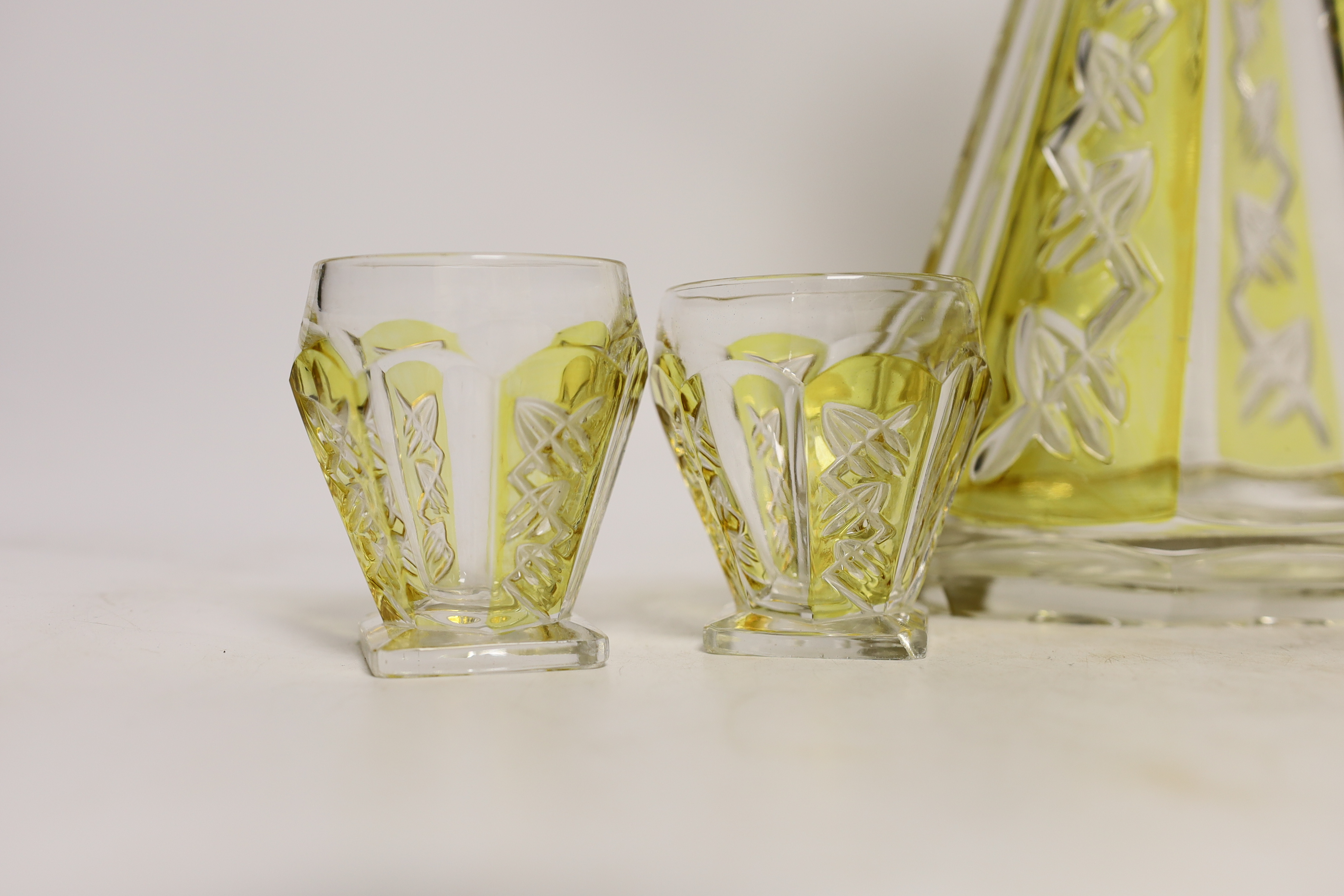 An Art Deco cut glass decanter with four glasses, decanter 29cm high